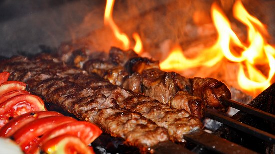 Kabobs cooking over an open flame